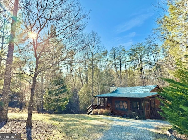 exterior space featuring a porch and metal roof