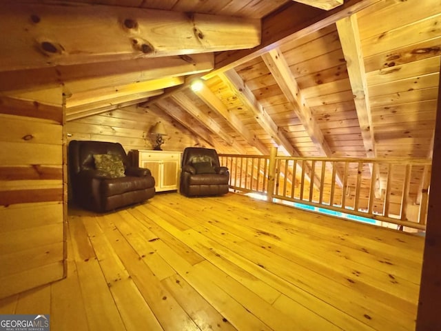 additional living space featuring vaulted ceiling with beams, light wood finished floors, wood ceiling, and wooden walls