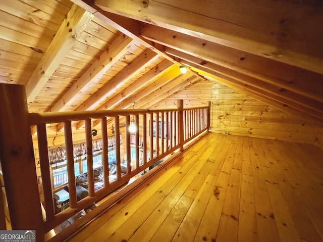 bonus room featuring vaulted ceiling, wooden ceiling, wood finished floors, and wooden walls