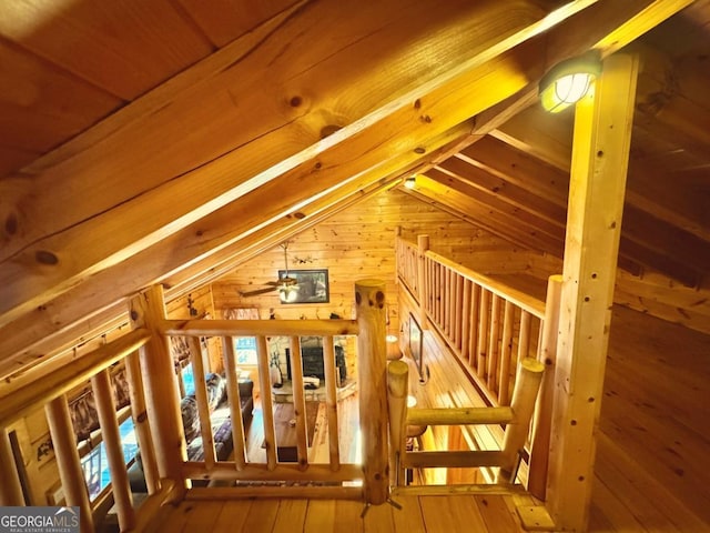 unfinished attic with an upstairs landing