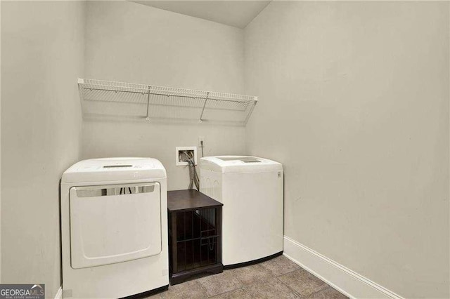 laundry area featuring laundry area, baseboards, and separate washer and dryer