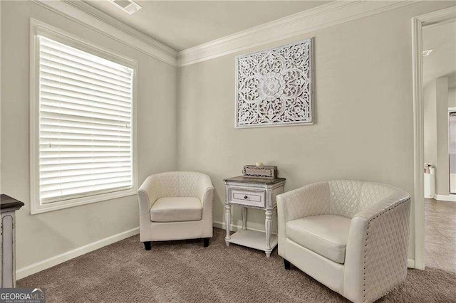 living area featuring baseboards, carpet floors, visible vents, and crown molding