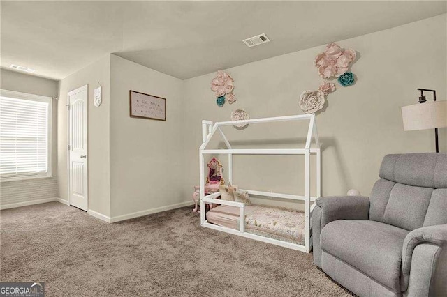 living area featuring baseboards, visible vents, and carpet flooring