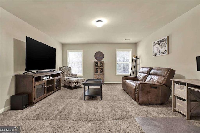 carpeted living room featuring visible vents and baseboards