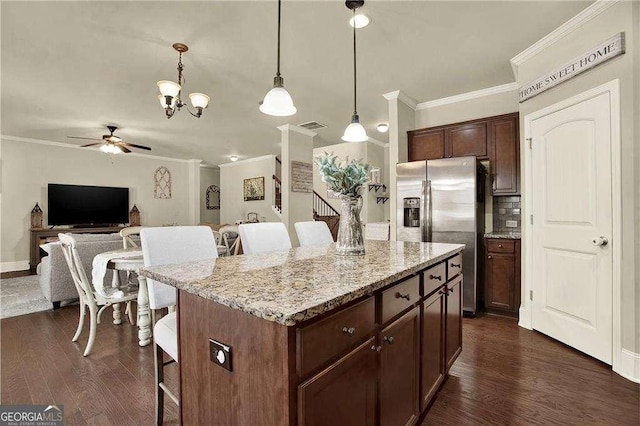 kitchen featuring ornamental molding, a breakfast bar, dark wood-style flooring, and stainless steel fridge with ice dispenser