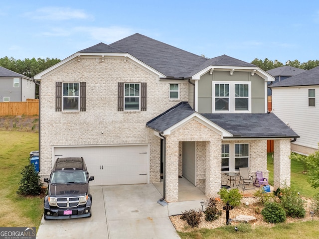 view of front of home with a shingled roof, concrete driveway, brick siding, and an attached garage