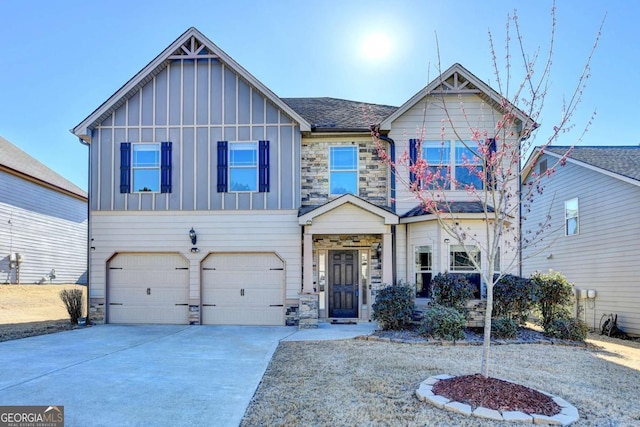 view of front of home featuring board and batten siding, stone siding, an attached garage, and concrete driveway