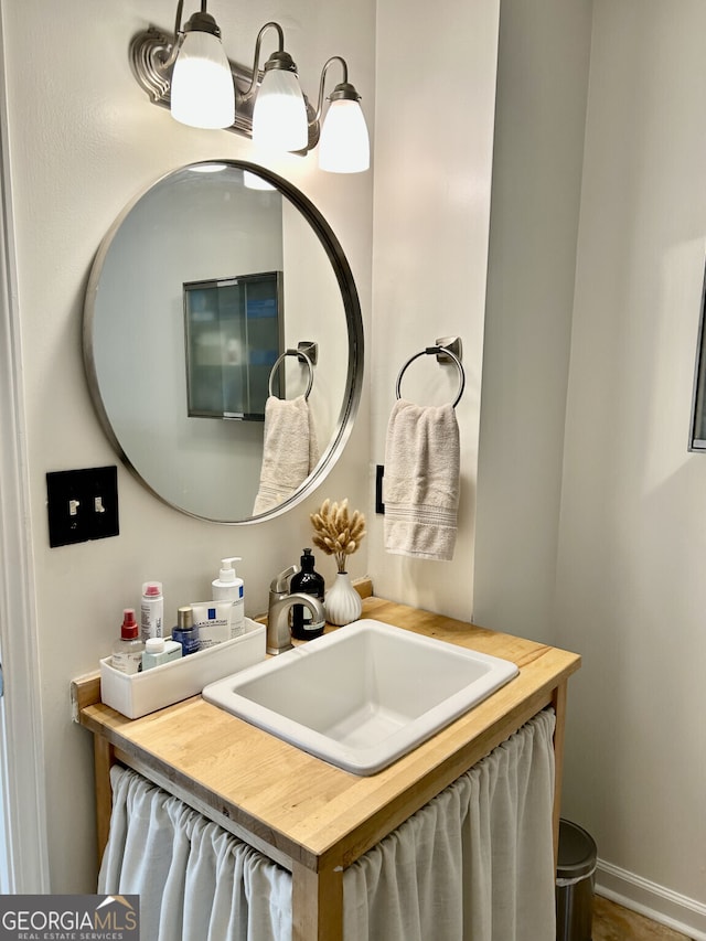 bathroom with vanity and baseboards