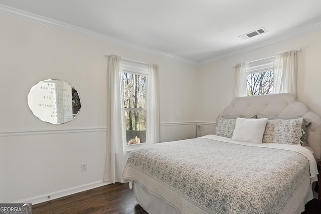 bedroom featuring crown molding, visible vents, baseboards, and dark wood-type flooring