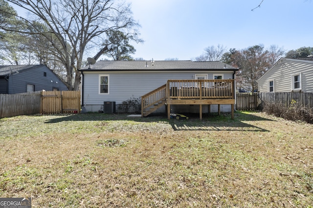 back of property featuring central air condition unit, a yard, a fenced backyard, and a wooden deck