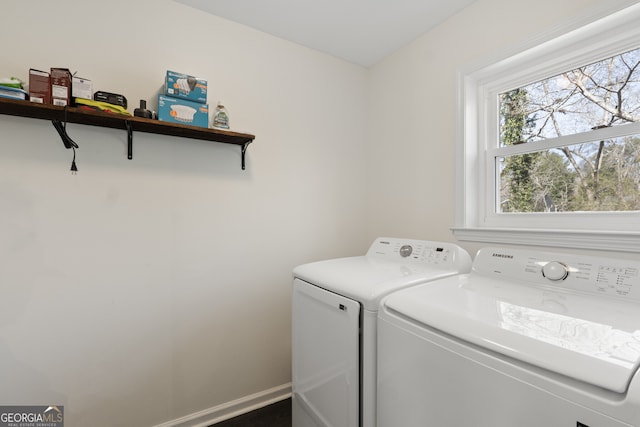 laundry area featuring laundry area, washer and clothes dryer, and baseboards