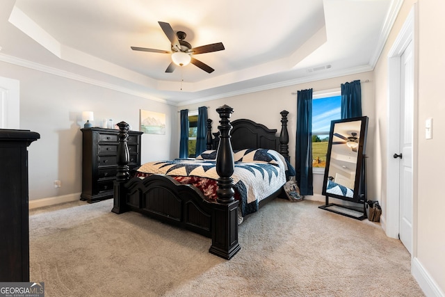 bedroom featuring carpet floors, a tray ceiling, and visible vents