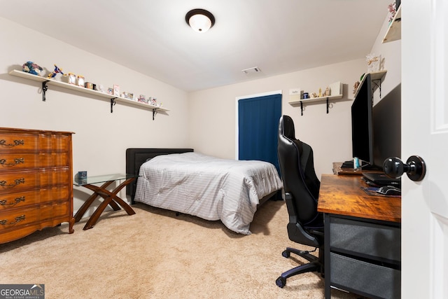 carpeted bedroom featuring visible vents