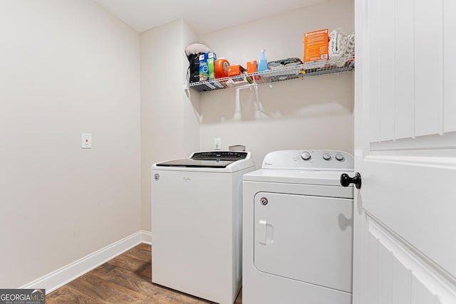 laundry room featuring laundry area, wood finished floors, washing machine and dryer, and baseboards