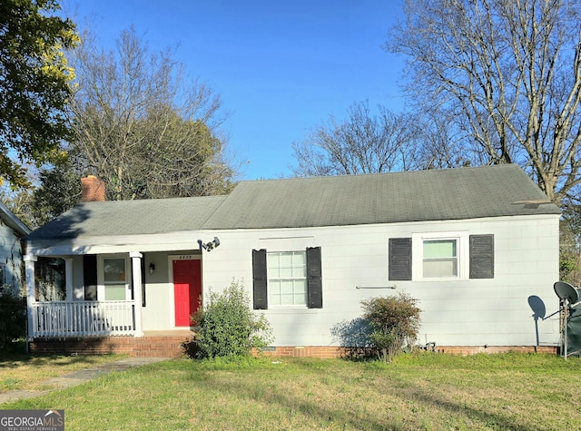 single story home featuring covered porch, crawl space, a front lawn, and a chimney