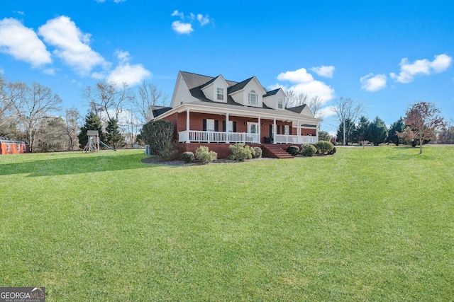 view of front of house featuring covered porch, brick siding, a playground, and a front yard