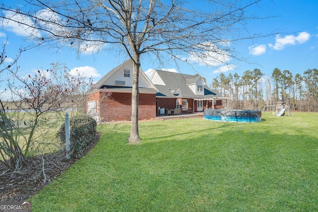 view of yard with a patio and a covered pool