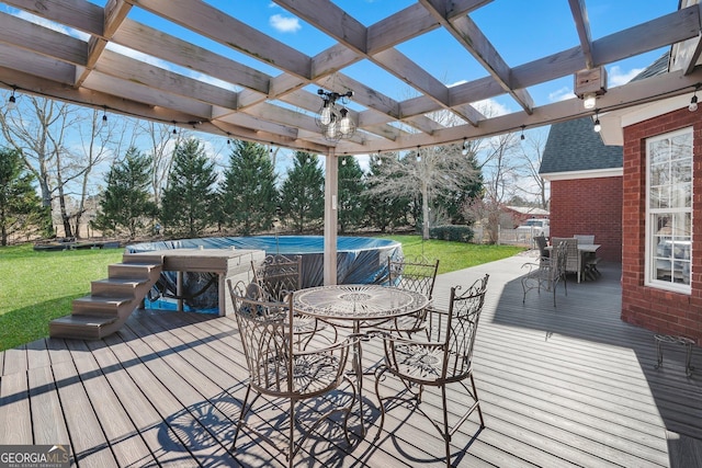 deck featuring a lawn, outdoor dining area, and a pergola