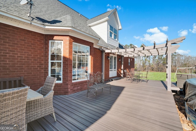 wooden terrace featuring outdoor dining space and a pergola