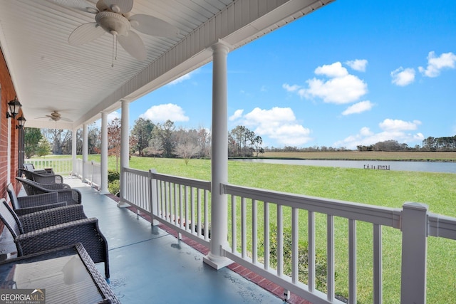 view of patio featuring a porch, a water view, and a ceiling fan