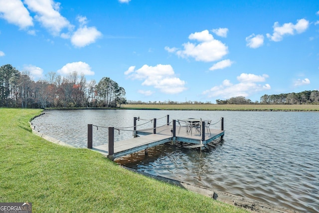 view of dock featuring a lawn and a water view