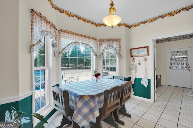 dining area featuring baseboards and light tile patterned flooring