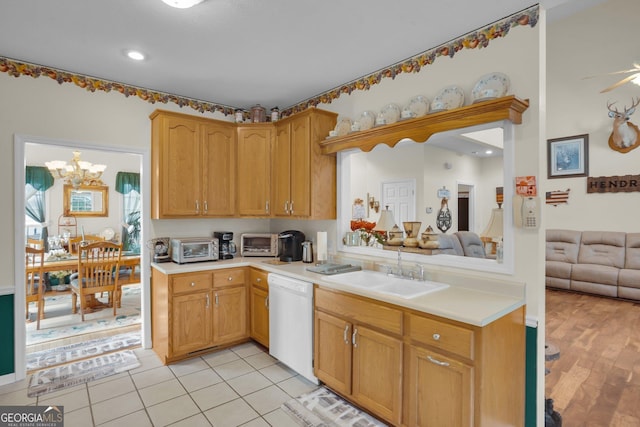 kitchen featuring a sink, a toaster, light countertops, and dishwasher