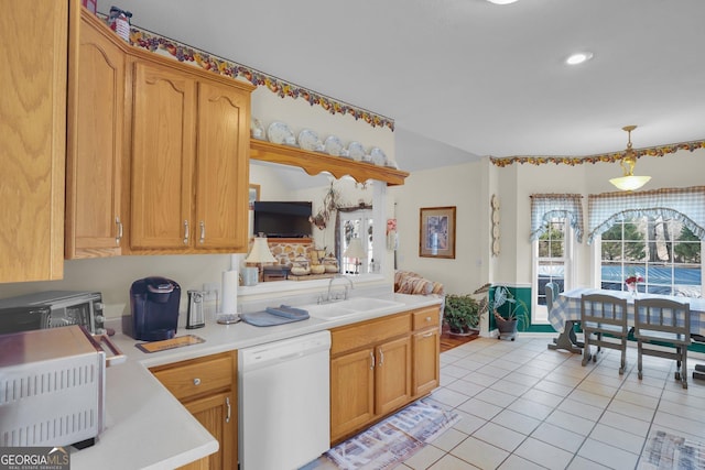 kitchen featuring light tile patterned floors, a sink, light countertops, hanging light fixtures, and dishwasher