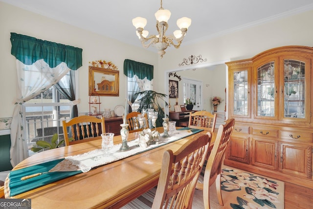 dining room featuring a chandelier, crown molding, and light wood-style flooring