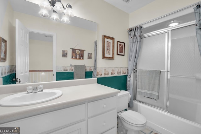 bathroom with toilet, enclosed tub / shower combo, a chandelier, and vanity