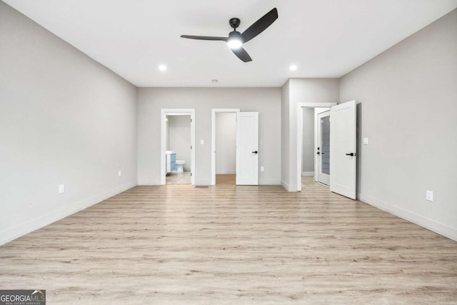 unfurnished bedroom featuring light wood finished floors, baseboards, connected bathroom, and recessed lighting