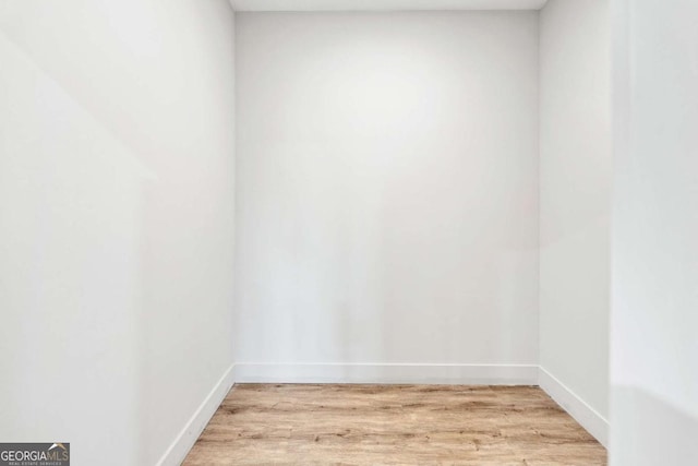 spare room with light wood-style floors and baseboards