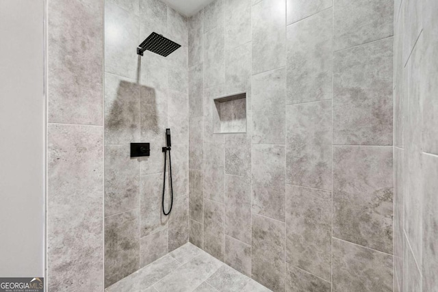 bathroom with tiled shower