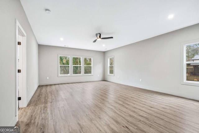 unfurnished room with baseboards and light wood finished floors