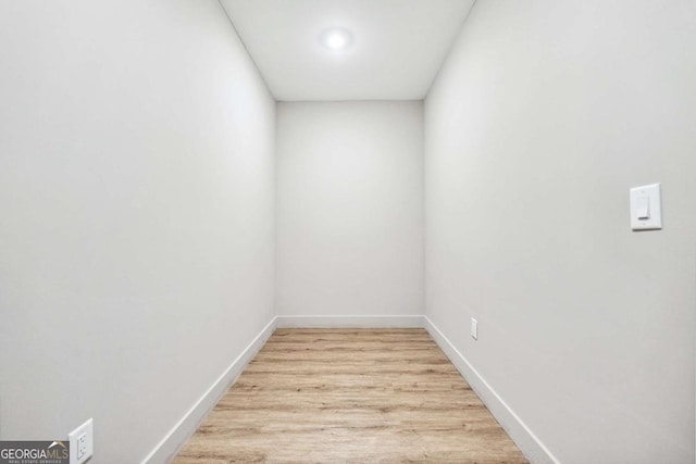 interior space featuring wood finished floors and baseboards