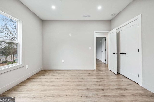 interior space with recessed lighting, light wood-type flooring, visible vents, and baseboards