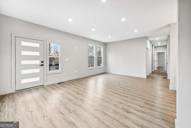 entryway with light wood-style floors, baseboards, and recessed lighting