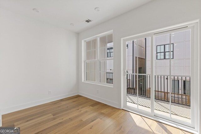 empty room with wood finished floors and baseboards