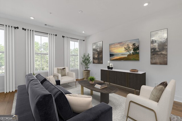 living room featuring wood finished floors, recessed lighting, and baseboards