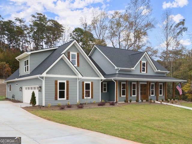 view of front of house with a porch, a front yard, driveway, and an attached garage