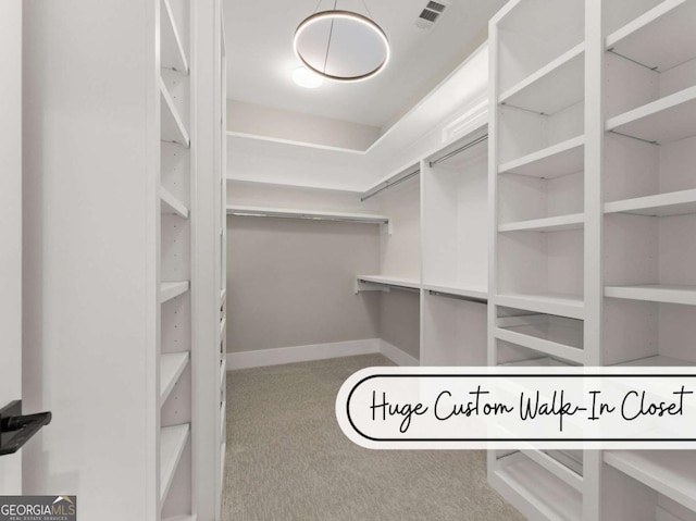 spacious closet with carpet floors and visible vents