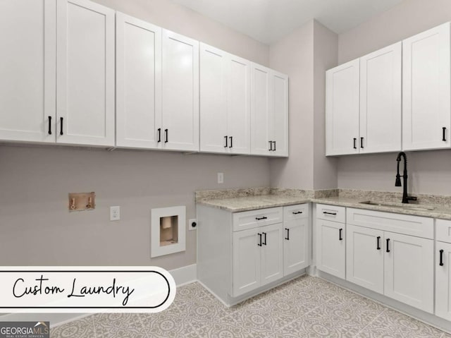 laundry room with cabinet space, a sink, electric dryer hookup, and hookup for a washing machine