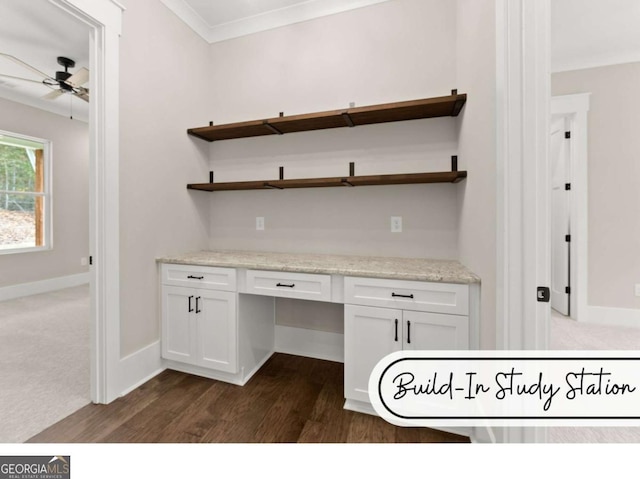 unfurnished office featuring ornamental molding, built in study area, a ceiling fan, and baseboards