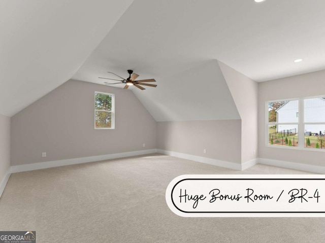 additional living space featuring lofted ceiling, recessed lighting, a ceiling fan, light carpet, and baseboards