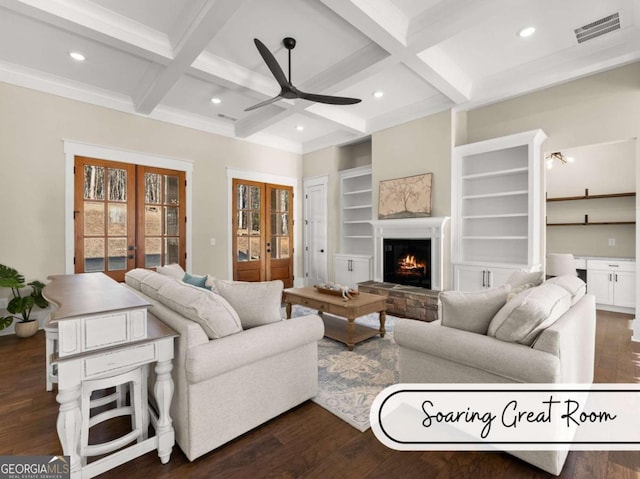 living room with a warm lit fireplace, dark wood-type flooring, visible vents, french doors, and beam ceiling