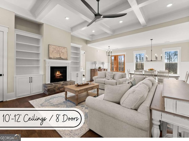 living area with recessed lighting, dark wood-type flooring, coffered ceiling, a lit fireplace, and beam ceiling