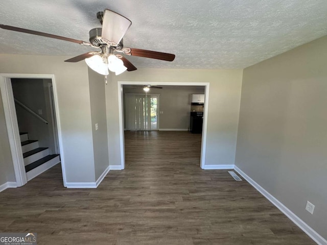 interior space featuring stairway, baseboards, dark wood finished floors, and a textured ceiling