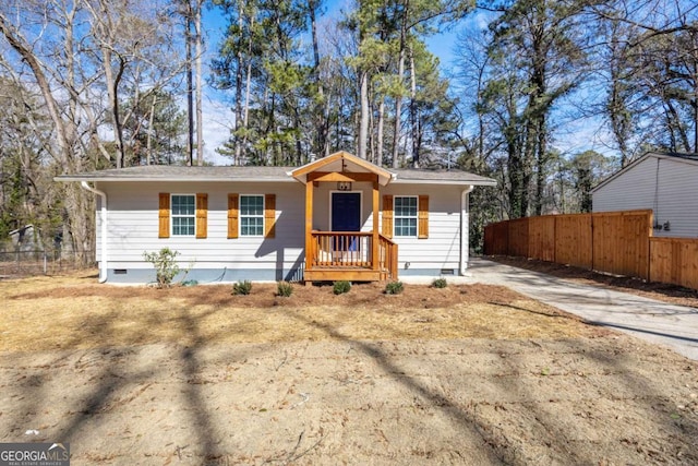 view of front facade featuring crawl space, driveway, and fence