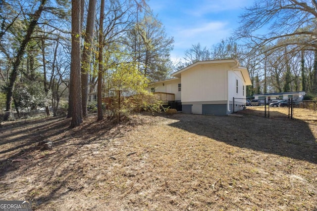 view of side of home featuring a gate and fence