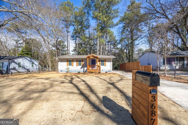 view of front facade featuring fence, driveway, and crawl space